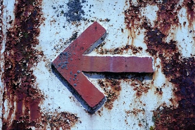 White and brown red arrow symbol of concrete wall
